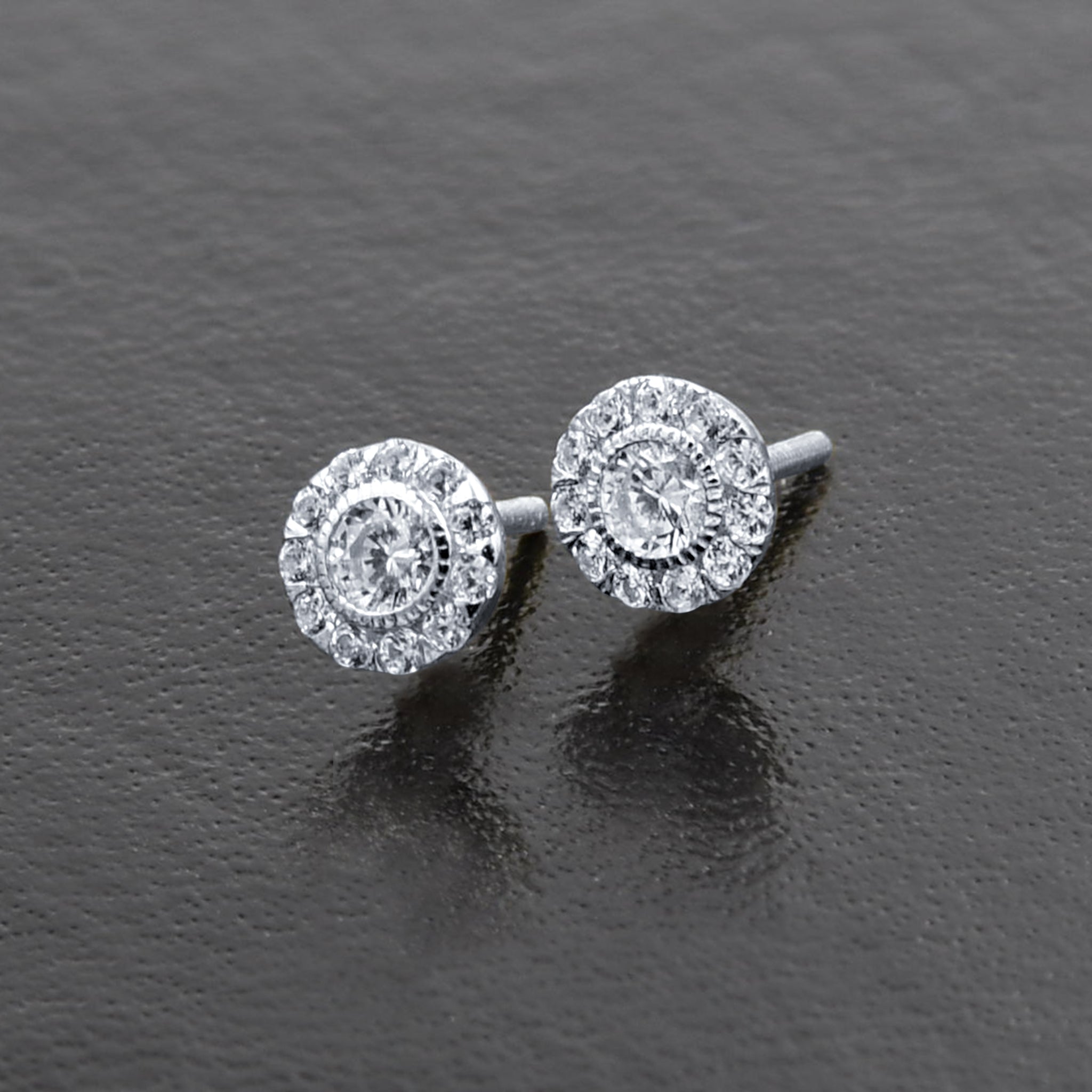 Close-up of ethnic style sterling silver stud earrings showcasing diamond-shaped cubic zirconia stones.