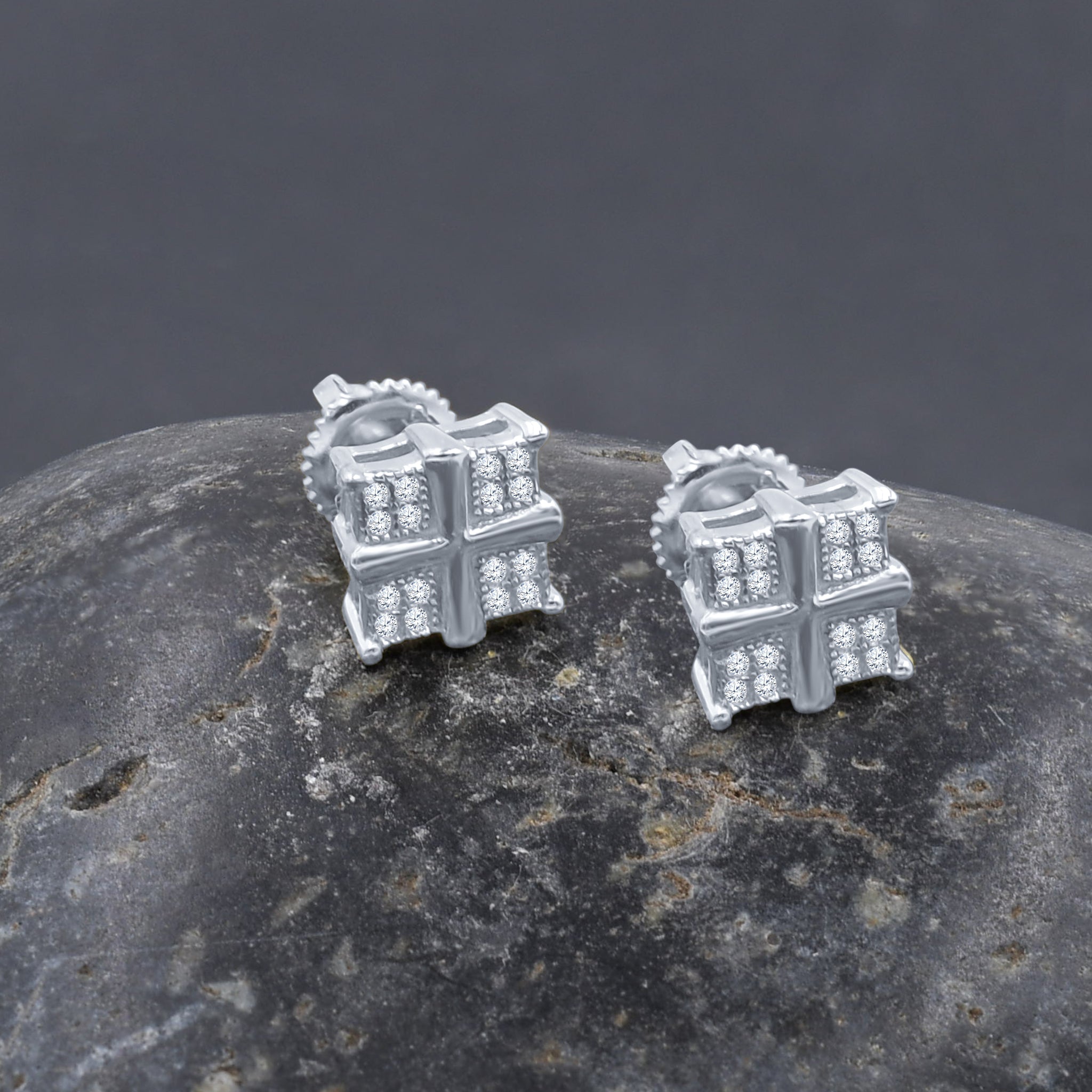 Close-up of gold plated miniature earrings showcasing cubic zirconia sparkle