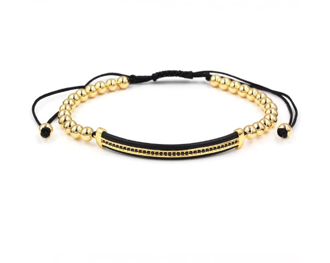 Close-up of Aureate Luxe steel bracelet showing golden beads and black center band