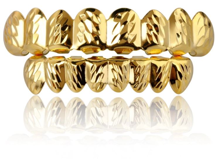 Close-up of diamond cut grillz showcasing intricate design and gold finish.